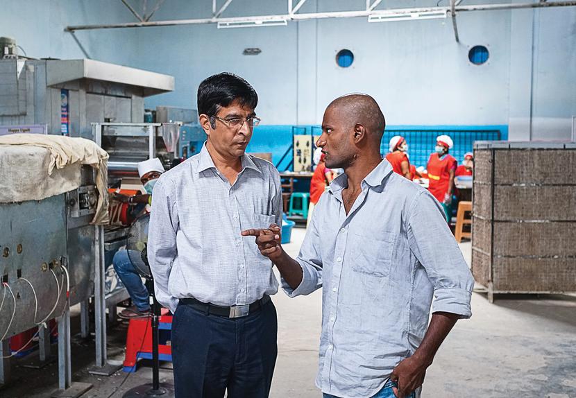 Bakeys founder Narayana Peesapaty (left) with one of his employees at the factory.